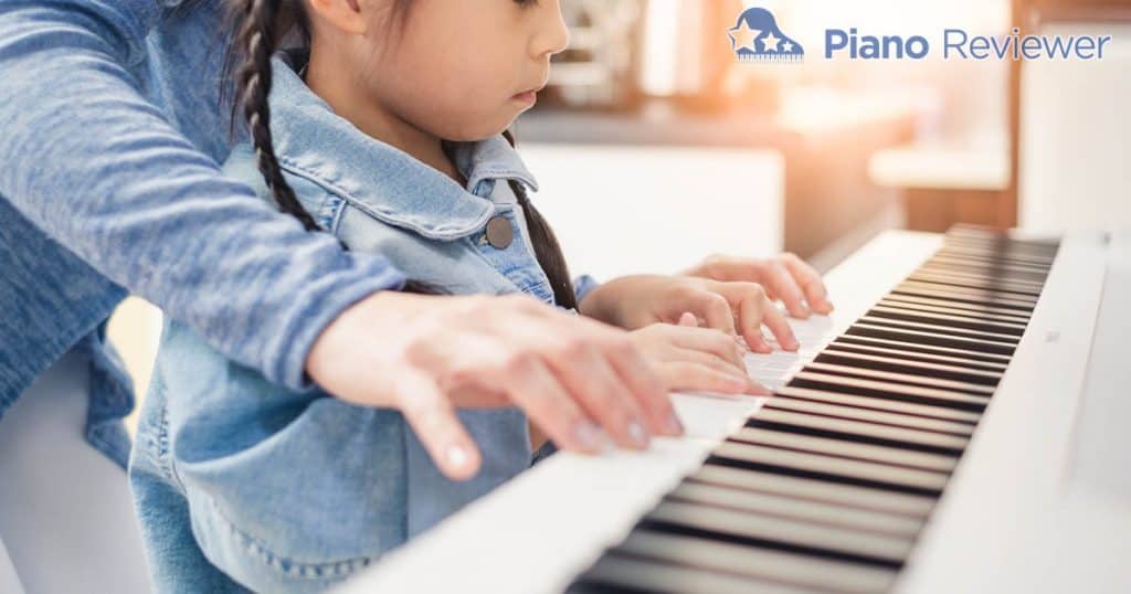 Child learning to play piano